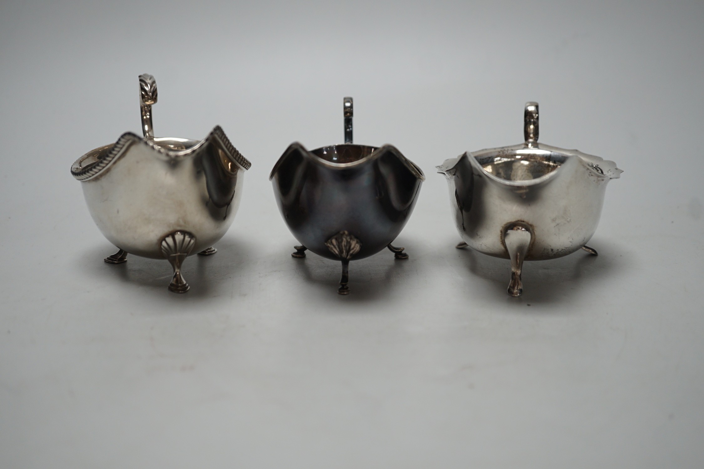 Three assorted 20th century silver sauceboats, longest 14.2cm